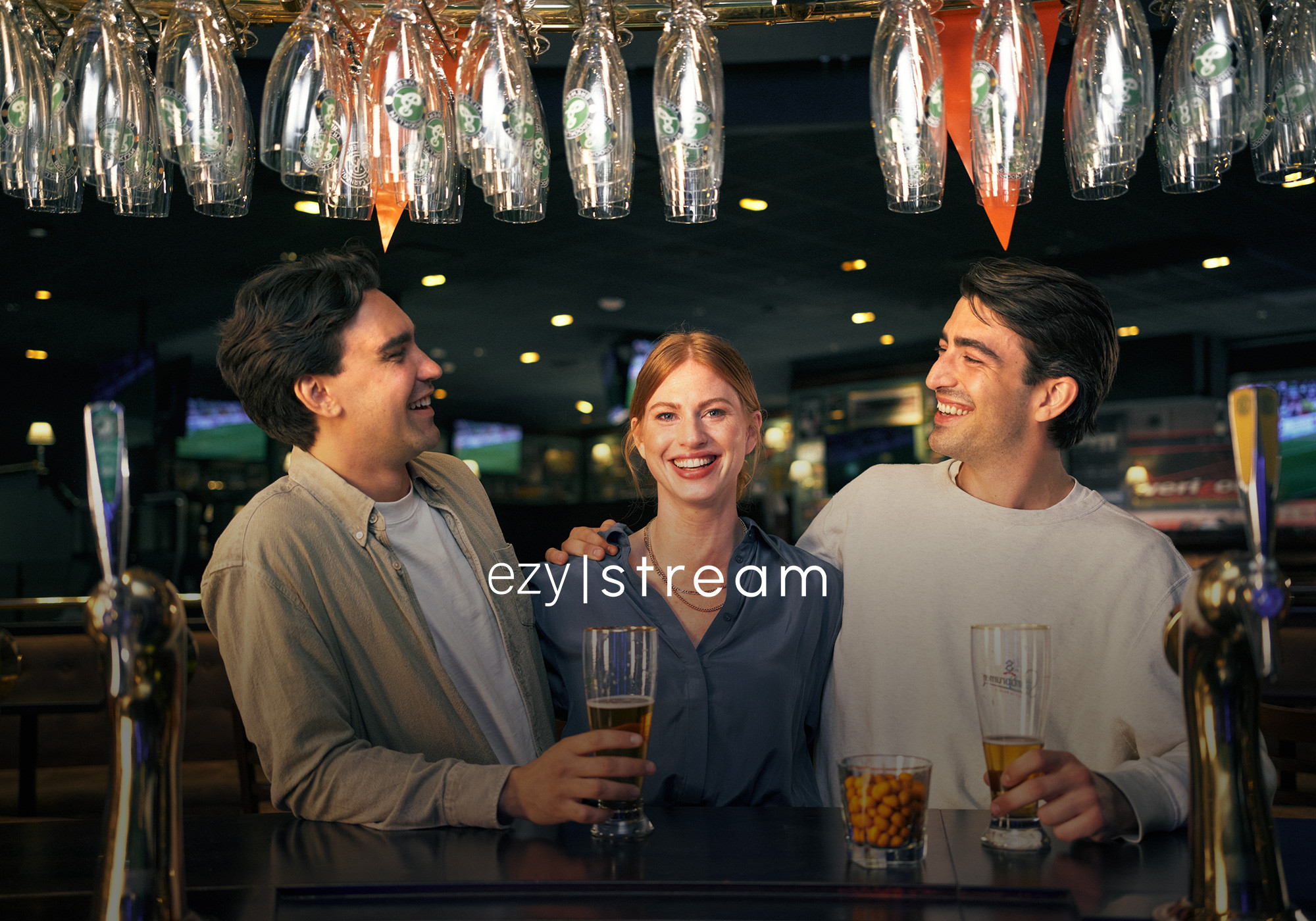 Three people socialising in a sports bar. Tre personer som umgås i en sportbar.