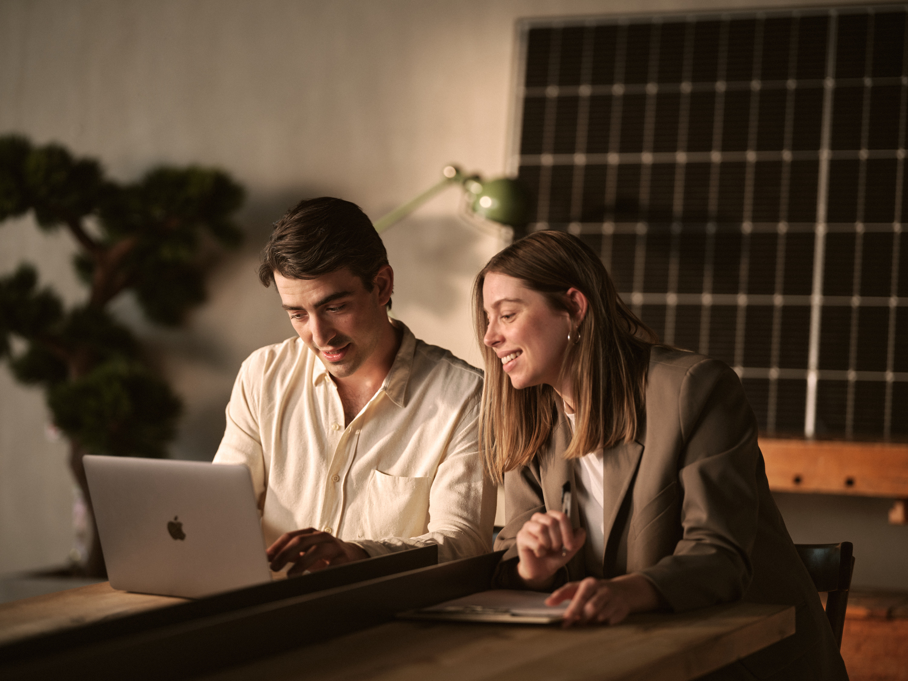 Two people sitting together at a laptop. Två personer som sitter tillsammans vid en laptop.